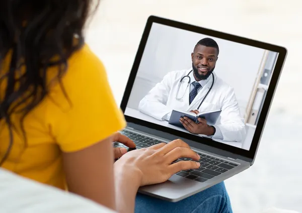 A patient speaks with a healthcare professional through a video consultation.